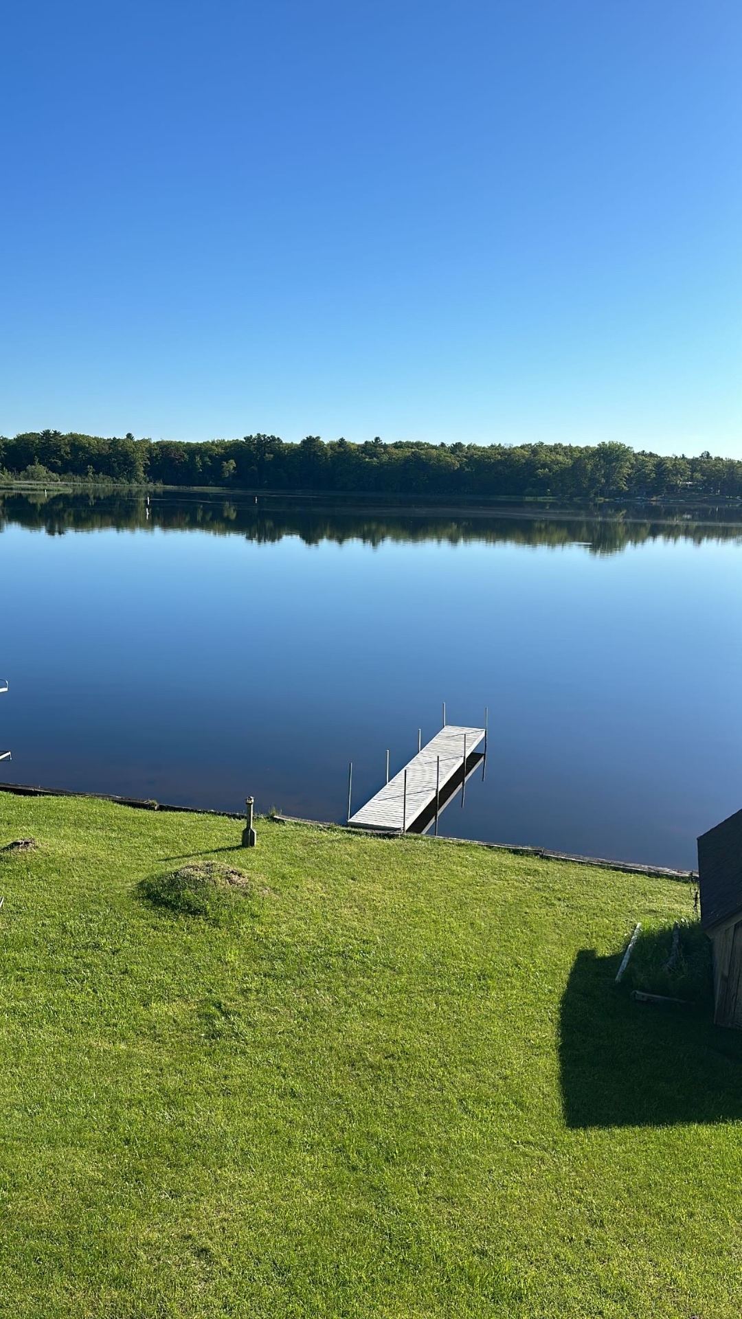 Private dock and calm water at Oscoda Lakehouse on Van Etten Lake